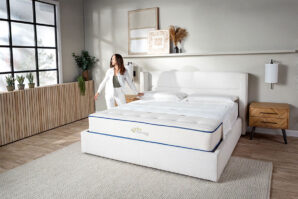 woman-standing-next-to-mattress
